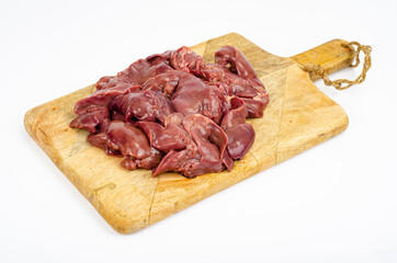 Raw chicken livers close-up on cutting board, ingredients for cooking, on white background. Studio Photo