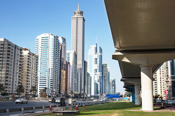 Naklejka premium UAE, Dubai. Towers and metro in the financial center of Dubai.