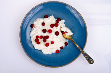 Fototapeta premium Dairy products. Fresh white homemade cottage cheese on blue plate. Studio Photo