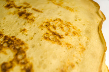 Fresh homemade pancakes on a plate close-up. Shrovetide. Pancake day. Maslenitsa. Cooked food for the holiday. Soft focus