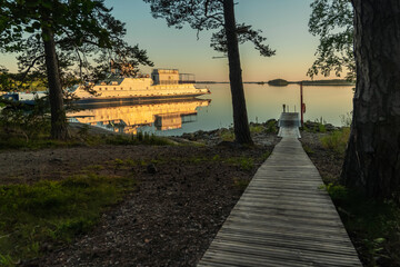 Ferry at the pier. Early, summer dawn. Nature of Scandinavia. Islands in the sea. Finland.