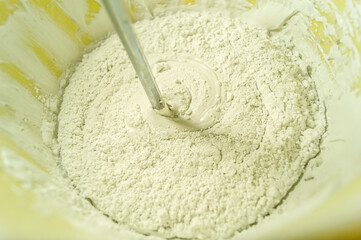White putty in a bucket of water. Preparation of mortar for finishing walls and ceilings in the apartment. Repair in the house. DIY. Selective focus