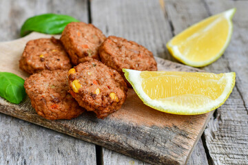 Home made  oven baked  mini meatballs  from  chicken and vegetable on  wooden background