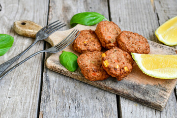 Home made  oven baked  mini meatballs  from  chicken and vegetable on  wooden background
