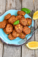 Home made  oven baked  mini meatballs  from  chicken and vegetable on  wooden background