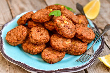 Home made  oven baked  mini meatballs  from  chicken and vegetable on  wooden background