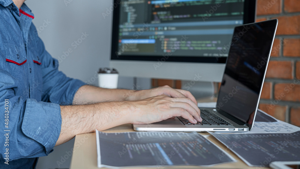 Leinwandbilder Young Professional programmer working at developing programming and website working in a software develop company office, writing codes and typing data code, Programming with HTML, PHP and javascript