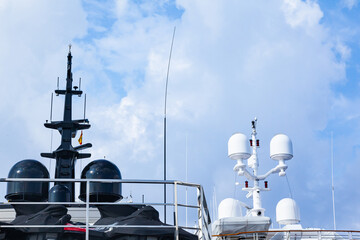 Mast of a large luxury yacht with navigation equipment, bottom view. Radars, signal lights,...
