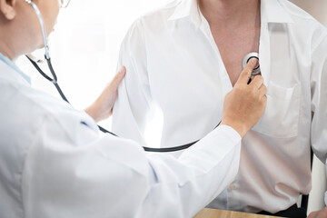 Doctor listening patient heartbeat with a stethoscope to diagnose heart rate examination, Medical and Healthcare concept