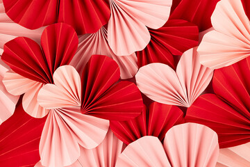 Fun Valentines day festive background in asian style - heap pink and red paper hearts of folded...