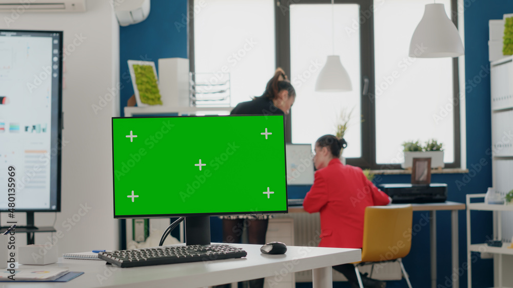 Poster close up of computer with blank green screen in business office. chroma key with isolated background