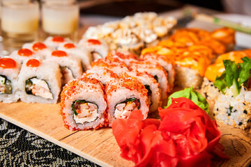 Set of various sushi rolls on a board. Close-up, selective focus
