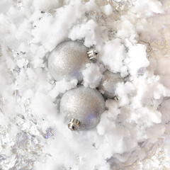 snowy frozen metallic iced background with silver balls coming out of it.holidays Christmas concept idea.New Year aesthetic