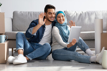 Happy middle-eastern family having online party with friends