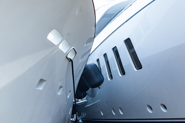 Two luxury motor yachts huddled together on fenders.