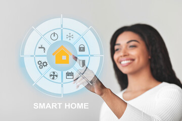 Happy black lady touching virtual Smart home screen