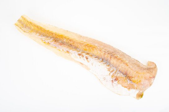 One frozen raw white fish fillet isolated on white background. Studio Photo