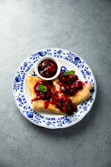 Homemade crepes with hot cherry sauce