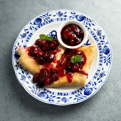 Homemade crepes with hot cherry sauce