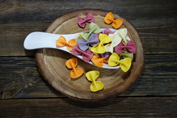 Colorful Italian pasta background. Various colors of  tie farfalle pasta. Selective focus. noodles