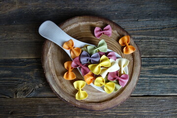 Colorful Italian pasta background. Various colors of  tie farfalle pasta. Selective focus. noodles