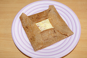Breton crepe with cheese and ham on a plate