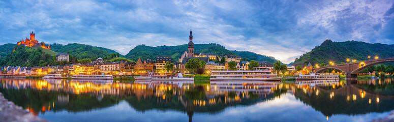Fototapeta premium Cochem, Rhineland-Palatinate, Germany - 03.06.2021. Panorama of the city of Cochem with Reichsburg Castle and the Moselle river in the evening. Night shot.