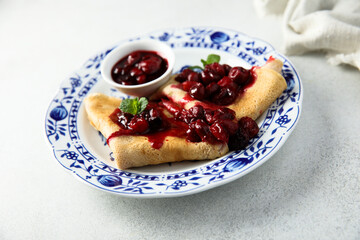 Homemade crepes with hot cherry sauce