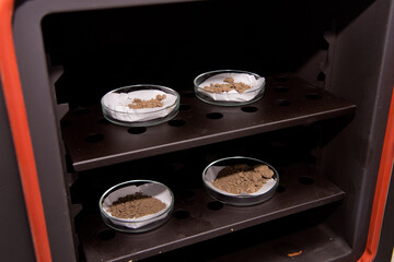 Glassware with soil samples. Laboratory research. Close-up.