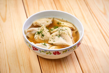 Tasty stuffed dumplings on wooden surface.