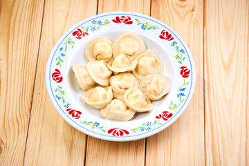 Tasty stuffed dumplings on wooden surface.