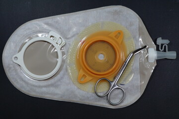 Urostomy and  nephrostomy bag - Ostomy medical care equipmen: Two-piece urostomy bag with the valve adhered to the skin of the patient. Ostomy plate for fixing urostomy bag