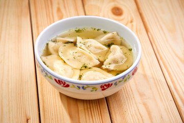 Tasty stuffed dumplings on wooden surface.