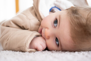 Happy baby crawling on floor or carpet