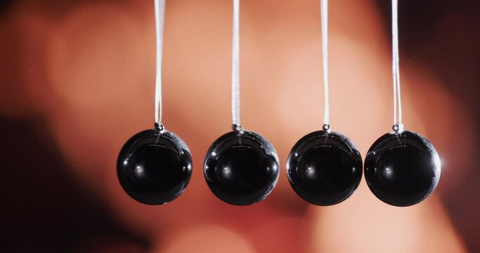 Newton's pendulum against the background of the fire. Energy transfer concept