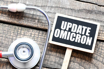 UPDATE OMICRON words on a small chalk board next to the stethoscope.