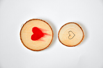 Pine tree slice with red blood heart symbol on white background. Valentines day wallpaper