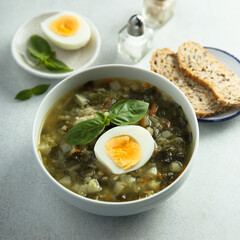 Traditional homemade green soup with hard boiled eggs