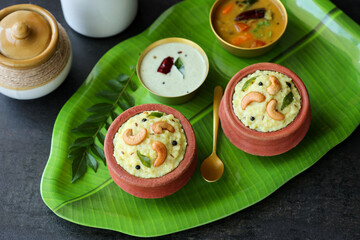 Ven Pongal Khara Pongal Sambar coconut chutney woman hand serving Indian breakfast food Tamil Nadu festival Pongal Sankranti Diwali spicy pongal using rice lentil semolina rava South India Sri Lanka