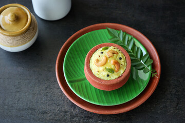 Ven Pongal Khara Pongal Sambar coconut chutney woman hand serving Indian breakfast food Tamil Nadu festival Pongal Sankranti Diwali spicy pongal using rice lentil semolina rava South India Sri Lanka