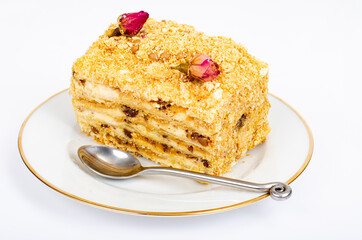 Piece of homemade puff pastry cake with cream on white plate. Studio Photo
