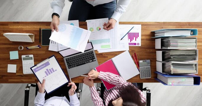 Team of business people discussing financial statistics in graphs