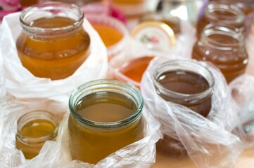 Fresh bee honey, dark brown and light golden, in containers