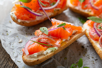 Sandwich with smoked salmon and cream cheese on a crispy baguette
