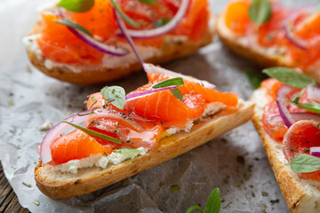 Sandwich with smoked salmon and cream cheese on a crispy baguette