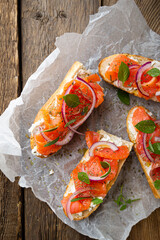 Sandwich with smoked salmon and cream cheese on a crispy baguette