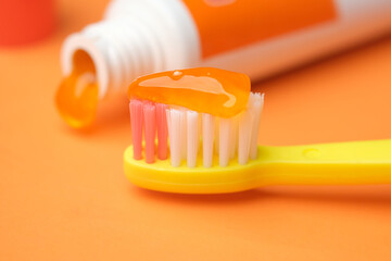  orange color child tooth brush with paste