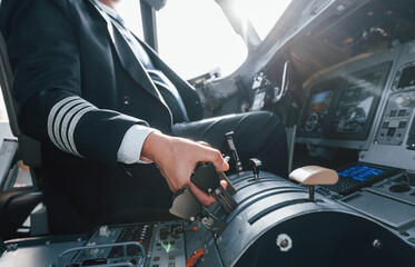 A professional pilot is in the cockpit. Conception of work