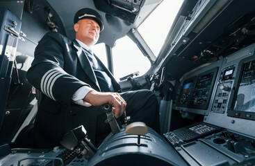 Naklejka premium A professional pilot is in the cockpit. Conception of work