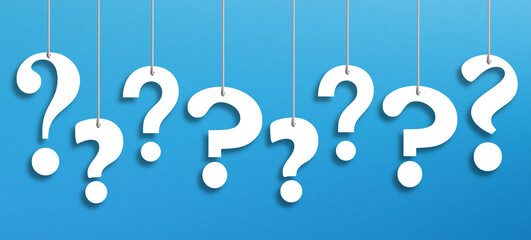 White question marks suspended by ropes on blue background